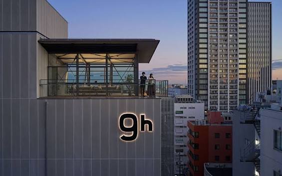 The 9h capsule hotel at dusk, with its rooftop terrace above the city.